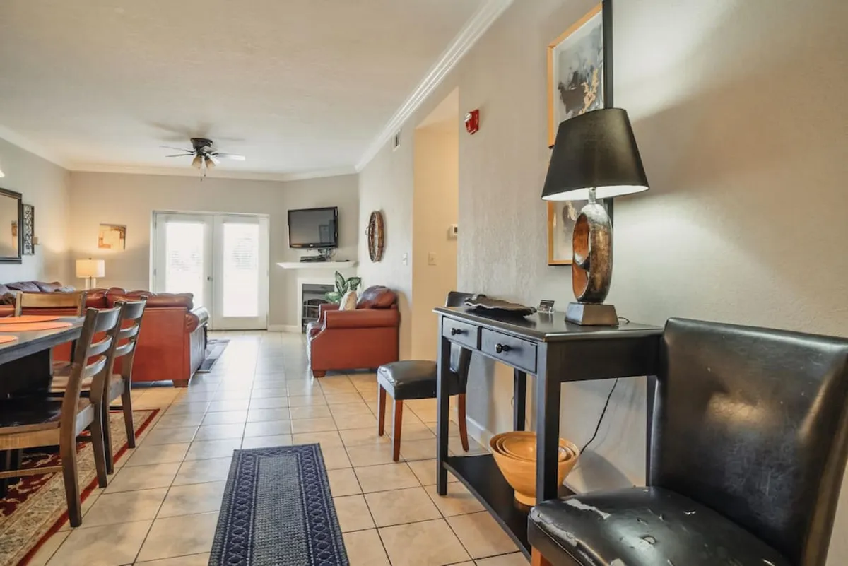 A cozy, well-lit living area with a dining table, sofa seating, television, and decorative accents, creating an inviting spot for relaxation and socializing. The space feels both luxurious and practical, ideal for unwinding or planning the next day's adventures.